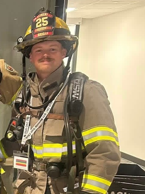 Bryce Brigan, owner of 5 Alarm Epoxy Coatings, in his firefighter turnout gear