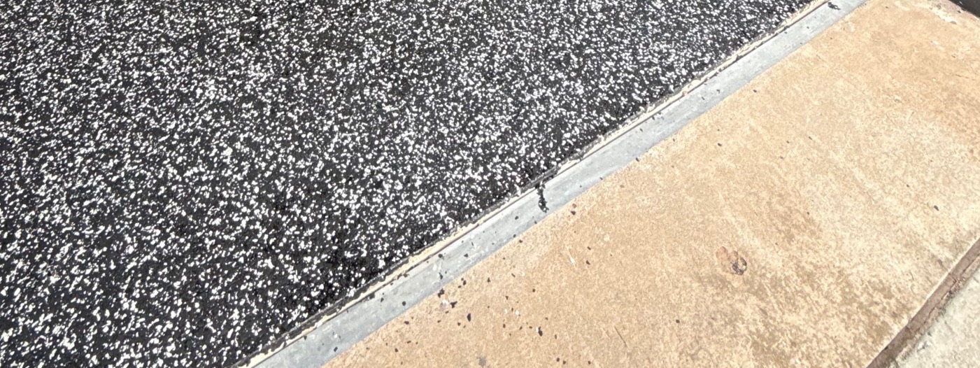 Clean edge of the flake floor where it meets the driveway at the garage door