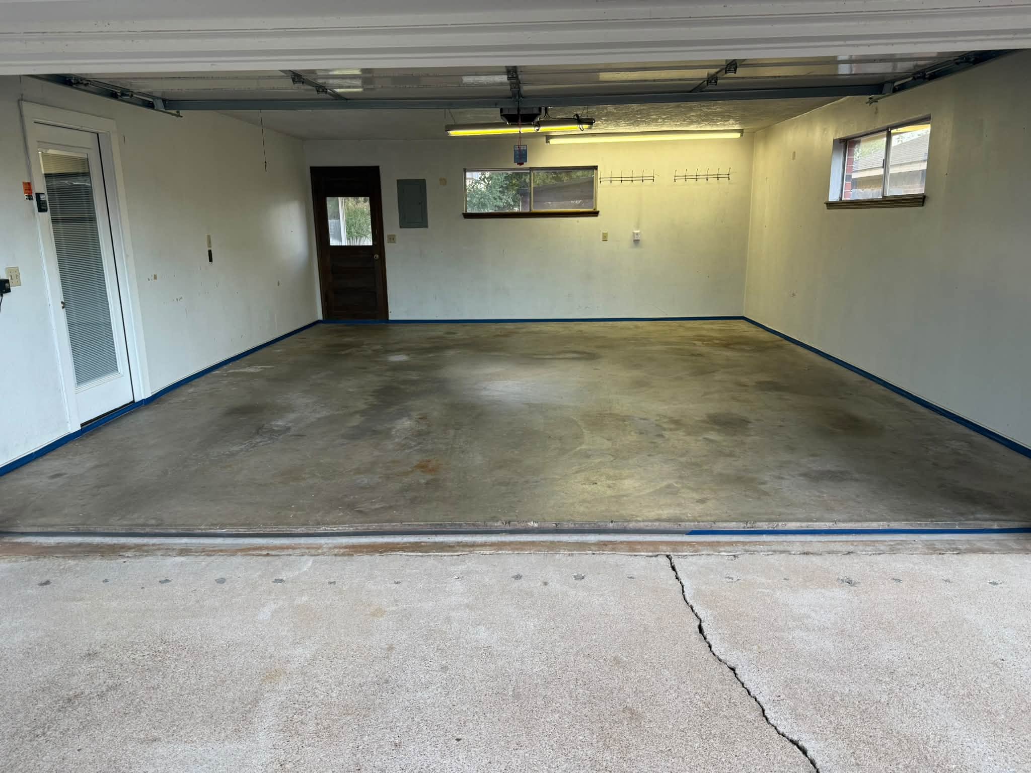 Stained two-car garage floor in Duncan before coating
