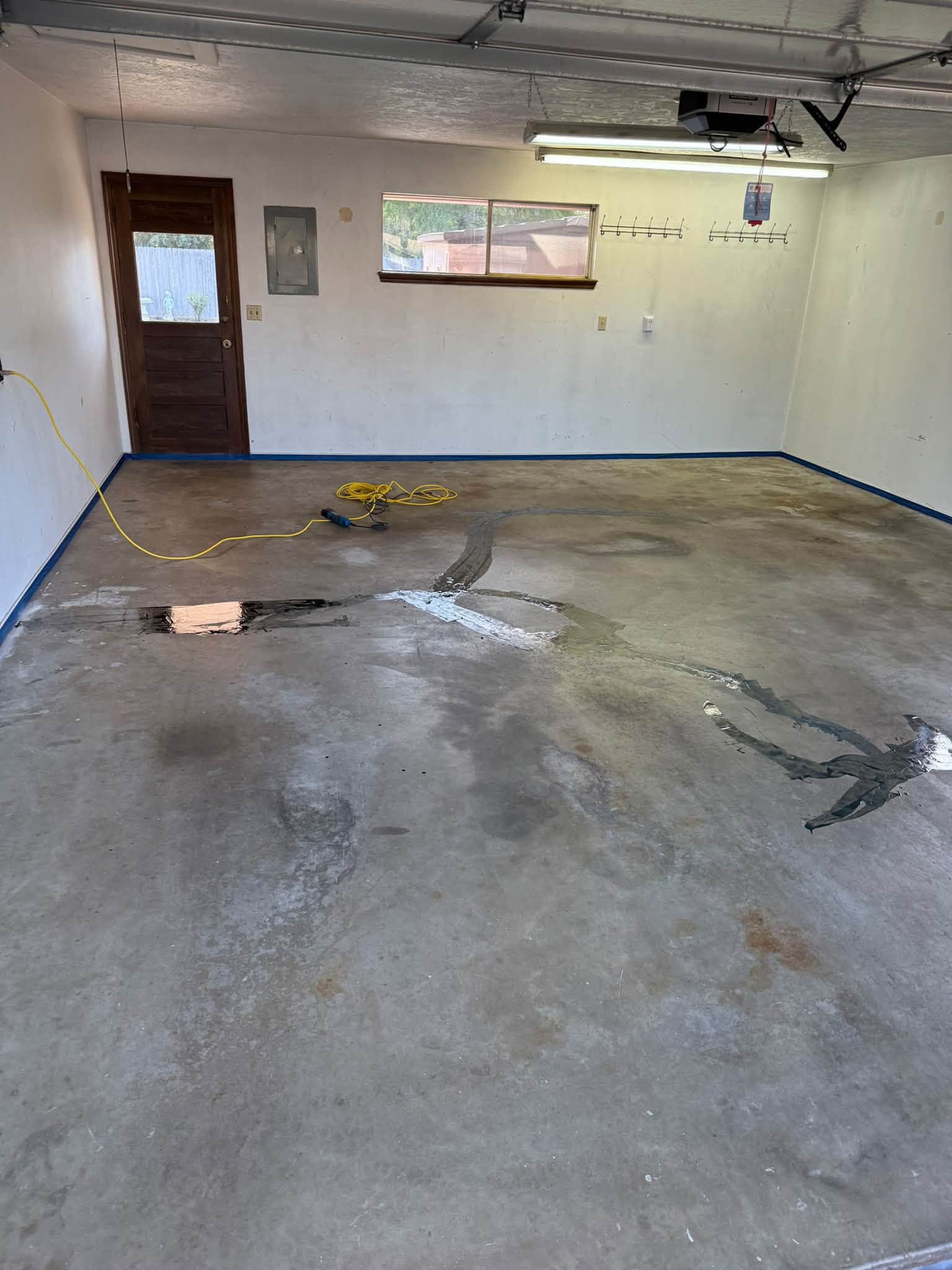 Cracks and low spots filled in the garage slab before grinding