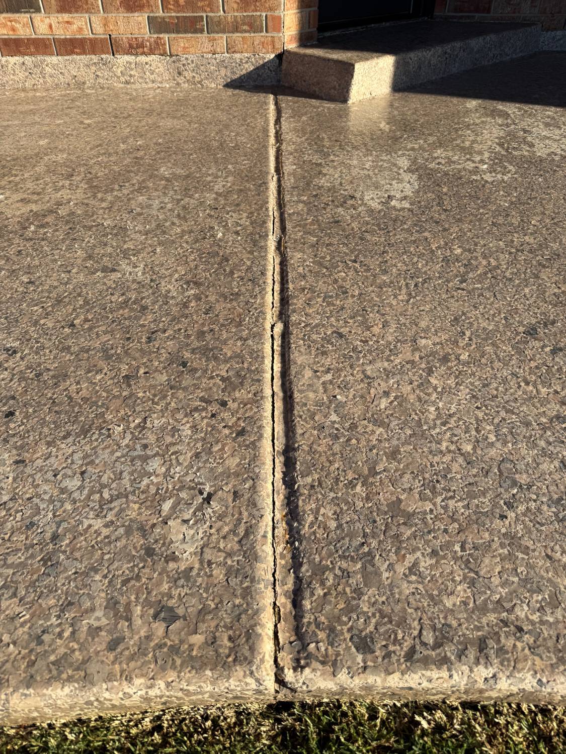 Crack along a patio control joint before re-caulking