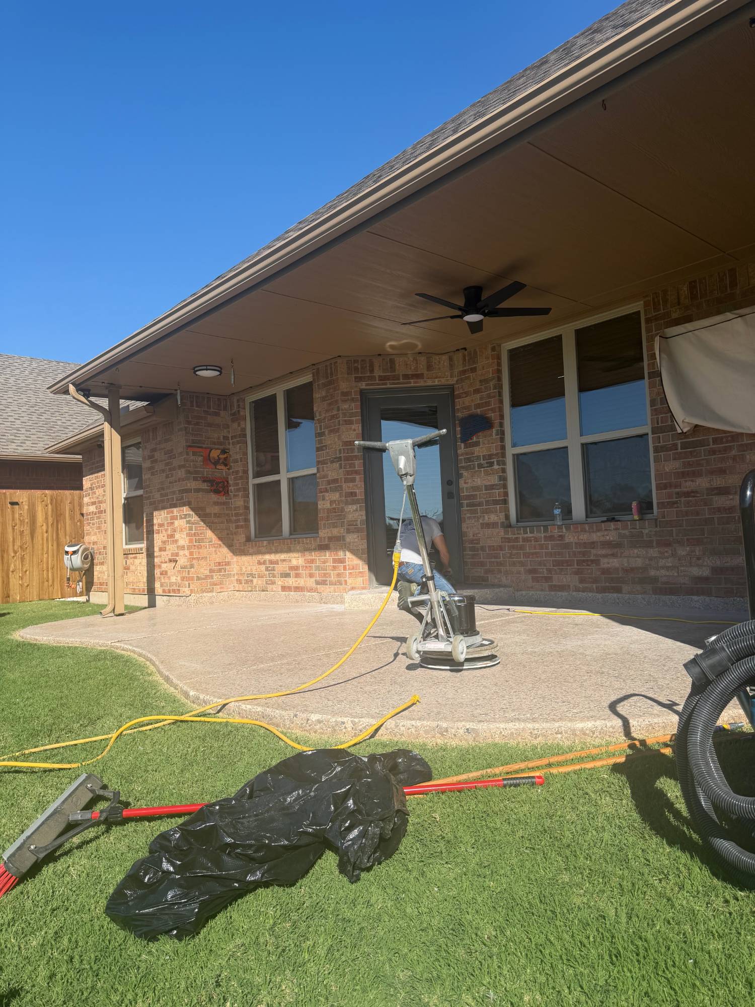 Floor machine sanding the old topcoat on the patio