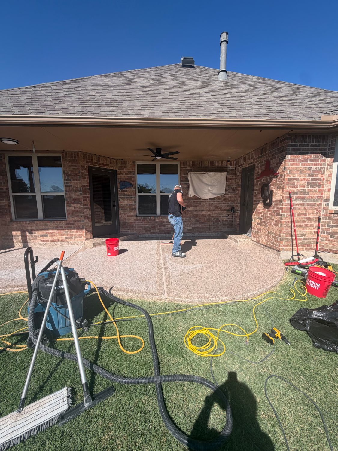 Bryce applying the new topcoat across the patio