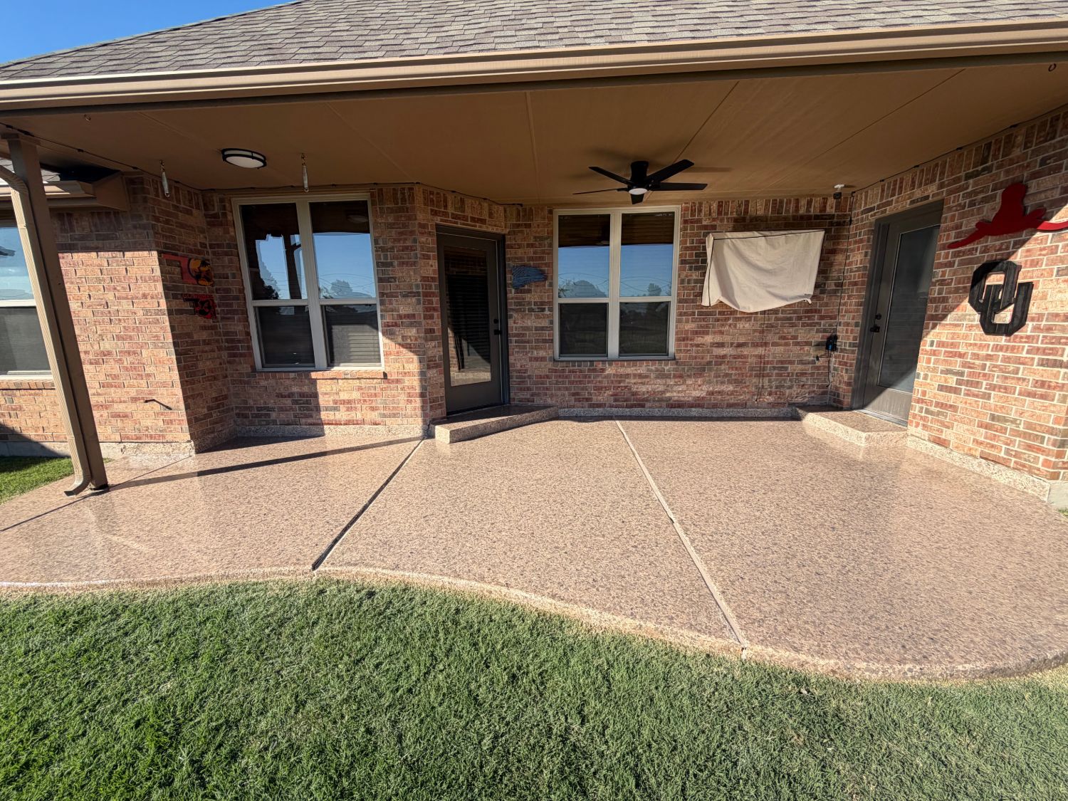 Back patio with a fresh glossy topcoat over tan flake