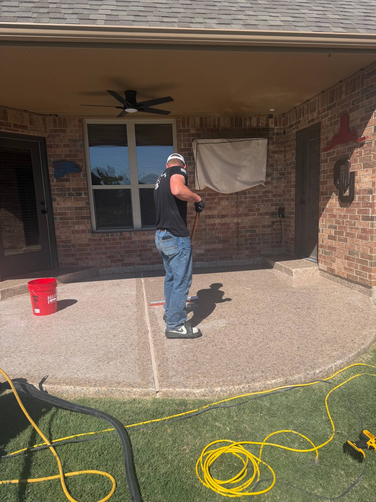 Bryce spreading topcoat with a squeegee