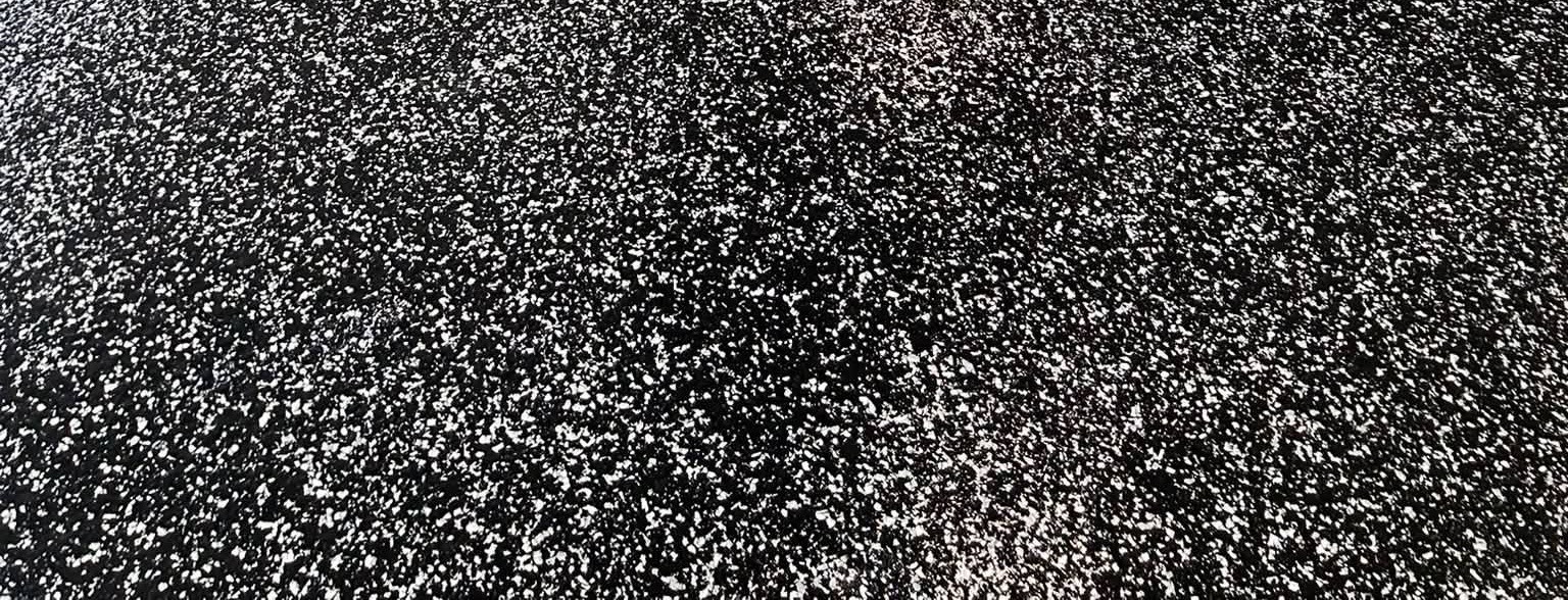 Close-up of Raven Torginol flake on a black base under a clear polyaspartic topcoat